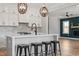 Modern kitchen featuring white cabinets, stainless steel appliances, and a large island with seating at 934 Woodland Rd, Creedmoor, NC 27522