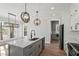 Beautiful kitchen with an island, stainless steel appliances, modern fixtures, and hardwood flooring at 934 Woodland Rd, Creedmoor, NC 27522
