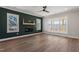 Bright living room featuring hardwood floors, a fireplace, and an abundance of natural light from the windows at 934 Woodland Rd, Creedmoor, NC 27522