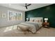 Serene main bedroom featuring stylish accent wall, a ceiling fan, and a bright window at 934 Woodland Rd, Creedmoor, NC 27522