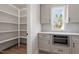 Functional pantry area featuring ample shelving, storage cabinets, and a convenient countertop microwave oven at 934 Woodland Rd, Creedmoor, NC 27522