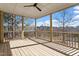 Inviting screened porch with natural wood flooring and ceiling fan, offering scenic views of the surrounding landscape at 934 Woodland Rd, Creedmoor, NC 27522