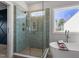 Shower with beautiful tile, glass door, and a bathtub near a bright window at 934 Woodland Rd, Creedmoor, NC 27522