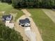 Aerial view of a single-Gathering home with a driveway surrounded by trees and grass at 9600 Stallings Rd, Spring Hope, NC 27882