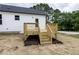 The backyard features a new wooden deck with steps, perfect for outdoor entertaining at 9600 Stallings Rd, Spring Hope, NC 27882