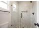 Modern bathroom with glass shower, white tile and decorative floral floor tiling at 9600 Stallings Rd, Spring Hope, NC 27882