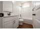 Bathroom with white cabinetry, quartz counters, wood-look floors, and black fixtures at 9600 Stallings Rd, Spring Hope, NC 27882