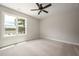 Bright bedroom with plush carpet, a large window and neutral paint at 9600 Stallings Rd, Spring Hope, NC 27882