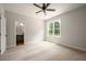 Cozy bedroom with plush carpet, a window view, and an ensuite bathroom and walk in closet at 9600 Stallings Rd, Spring Hope, NC 27882