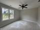 Bedroom features a modern ceiling fan, natural light, and neutral-colored walls at 9600 Stallings Rd, Spring Hope, NC 27882