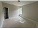 Unfinished bedroom with window, neutral paint and adjacent doorway at 9600 Stallings Rd, Spring Hope, NC 27882