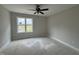 Bedroom with neutral walls, white trim, and window overlooking the outdoors at 9600 Stallings Rd, Spring Hope, NC 27882