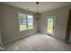 The dining room with modern lighting and a glass patio door at 9600 Stallings Rd, Spring Hope, NC 27882