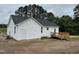 Exterior view shows the house and a wooden deck overlooking a large backyard at 9600 Stallings Rd, Spring Hope, NC 27882