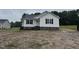 A single story new construction home with black shutters and stone foundation at 9600 Stallings Rd, Spring Hope, NC 27882