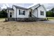 New construction home featuring white siding, stone accents, and a well-manicured lawn at 9600 Stallings Rd, Spring Hope, NC 27882