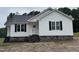 Charming single-story home featuring white siding, black shutters, and a stone foundation at 9600 Stallings Rd, Spring Hope, NC 27882