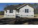 New construction home exterior featuring a white front door, grey shingles, and block foundation at 9600 Stallings Rd, Spring Hope, NC 27882