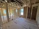 Framed room with subfloor, stud walls, visible ductwork, and natural light from windows at 9600 Stallings Rd, Spring Hope, NC 27882