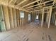 Spacious framed room with subfloor, stud walls, visible ductwork, and natural light at 9600 Stallings Rd, Spring Hope, NC 27882