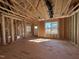 Interior framing showcasing open layout, stud walls, subfloor and natural light from windows at 9600 Stallings Rd, Spring Hope, NC 27882