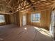 Interior view of a framed home with subfloor, stud walls, natural light from windows and door at 9600 Stallings Rd, Spring Hope, NC 27882