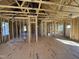 Interior of a framed home showing stud walls, subfloor, ductwork, and natural light from windows at 9600 Stallings Rd, Spring Hope, NC 27882