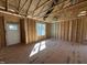 Spacious room with exposed studs, subfloor, and a bright window offering natural light at 9600 Stallings Rd, Spring Hope, NC 27882