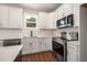 Well-lit kitchen with white cabinets, subway tile backsplash, and stainless steel appliances at 9600 Stallings Rd, Spring Hope, NC 27882