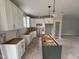 Bright kitchen featuring white cabinets, a stylish pantry door, and a dark green kitchen island at 9600 Stallings Rd, Spring Hope, NC 27882
