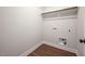 This laundry room features wood-look flooring and a closet rod for hanging clothes at 9600 Stallings Rd, Spring Hope, NC 27882