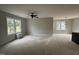 Bright living room with ceiling fan and large windows offering ample natural light at 9600 Stallings Rd, Spring Hope, NC 27882