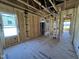 Open living room with natural light, framed with high ceilings, ready for finishes at 9600 Stallings Rd, Spring Hope, NC 27882