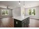 Open-concept living room with kitchen island, hardwood floors and modern light fixtures at 9600 Stallings Rd, Spring Hope, NC 27882