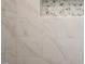 Detail of a white tiled shower featuring a decorative floral accent tile at 9600 Stallings Rd, Spring Hope, NC 27882