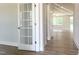 Bright entryway features a glass French door that leads to an open-concept layout with hardwood floors at 98 Tee Time Ter, Benson, NC 27504