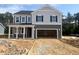 Two-story home featuring gray siding, white trim, covered porch, and an attached two car garage at 98 Tee Time Ter, Benson, NC 27504