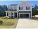 Charming two-story home showcasing a neutral color scheme, a two-car garage, and a well-manicured lawn at 98 Tee Time Ter, Benson, NC 27504