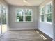 Sunlit sunroom with large windows and a sliding door, perfect for enjoying the outdoors at 98 Tee Time Ter, Benson, NC 27504