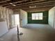 Spacious unfinished basement with framed walls, insulation, and a concrete floor, ready to be converted at 101 Parkland Dr, Pittsboro, NC 27312