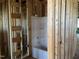 Bathroom under construction featuring a new tub, plumbing, and wood framing at 101 Parkland Dr, Pittsboro, NC 27312