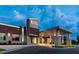 Modern building with UNC Healthcare logo, stone pillars, and inviting entrance under dramatic sky at 101 Parkland Dr, Pittsboro, NC 27312