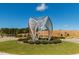 A modern metal sculpture enhances the landscaped roundabout within the Chatham Park community at 101 Parkland Dr, Pittsboro, NC 27312