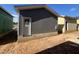 New construction exterior featuring a gray-tone siding, white trim and door, and foundation details at 101 Parkland Dr, Pittsboro, NC 27312