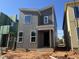 Modern two-story home under construction with a stylish gray exterior, showcasing its contemporary design at 101 Parkland Dr, Pittsboro, NC 27312