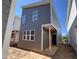Gray two-story home with white window trim and a minimalist design in a construction zone at 101 Parkland Dr, Pittsboro, NC 27312