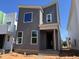 Modern gray two-story home with white window trim and a minimalist design in a construction zone at 101 Parkland Dr, Pittsboro, NC 27312