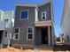Modern gray two-story home with white window trim and a minimalist design in a construction zone at 101 Parkland Dr, Pittsboro, NC 27312