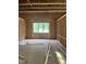 Unfinished interior room with stud framing, a window, and plumbing in place for future fixtures at 101 Parkland Dr, Pittsboro, NC 27312