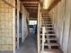 Unfinished staircase framed in studs, leading to the second floor, ready for customization at 101 Parkland Dr, Pittsboro, NC 27312